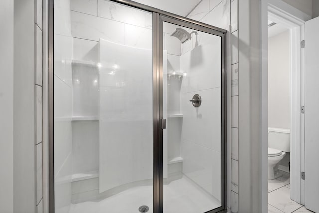 bathroom with toilet and walk in shower