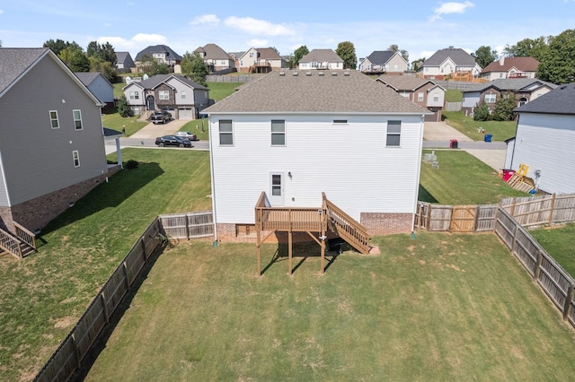 back of property with a yard and a deck