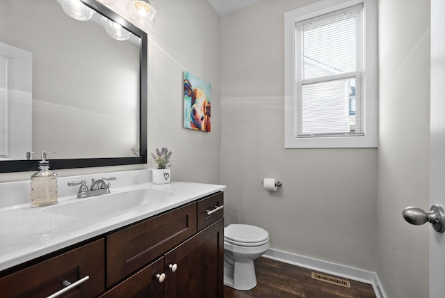 bathroom featuring vanity, toilet, and hardwood / wood-style floors