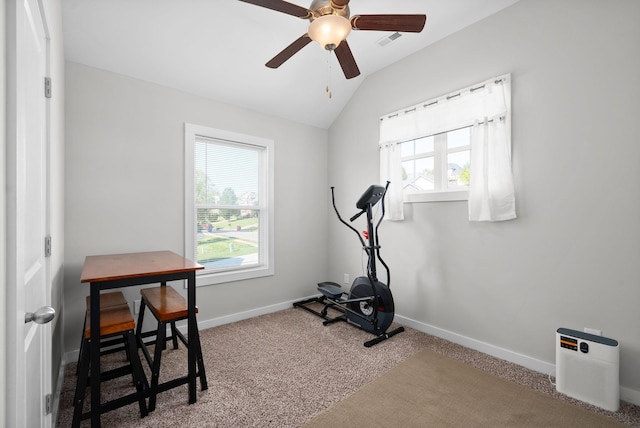 exercise area featuring vaulted ceiling, carpet, and ceiling fan