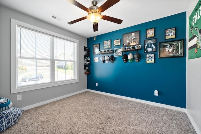 interior space featuring ceiling fan and carpet