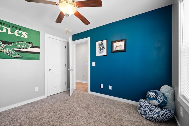 unfurnished bedroom with ceiling fan and carpet flooring