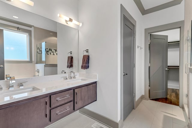 bathroom with vanity, tile patterned flooring, and walk in shower