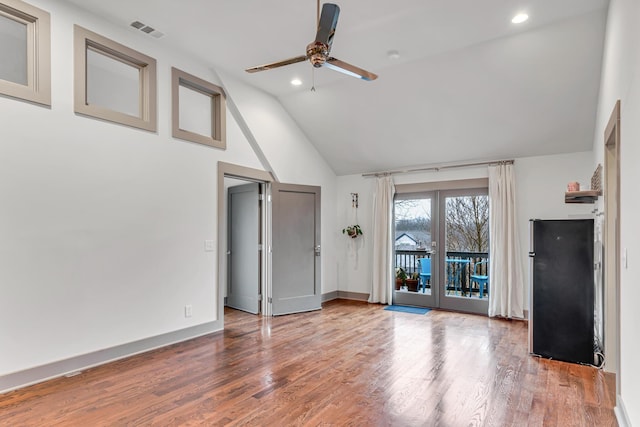 unfurnished living room with lofted ceiling, hardwood / wood-style floors, french doors, and ceiling fan