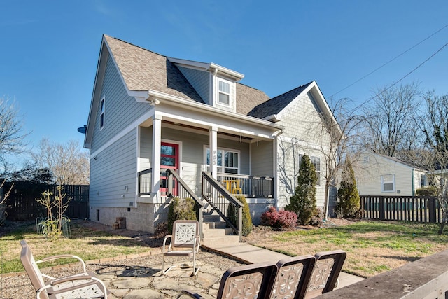 bungalow with covered porch and a front yard