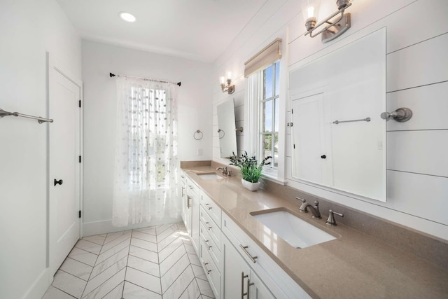 bathroom featuring vanity, tile patterned flooring, and a healthy amount of sunlight