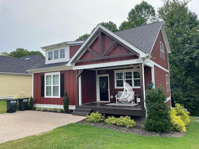 view of front of property with a shingled roof, a porch, and board and batten siding