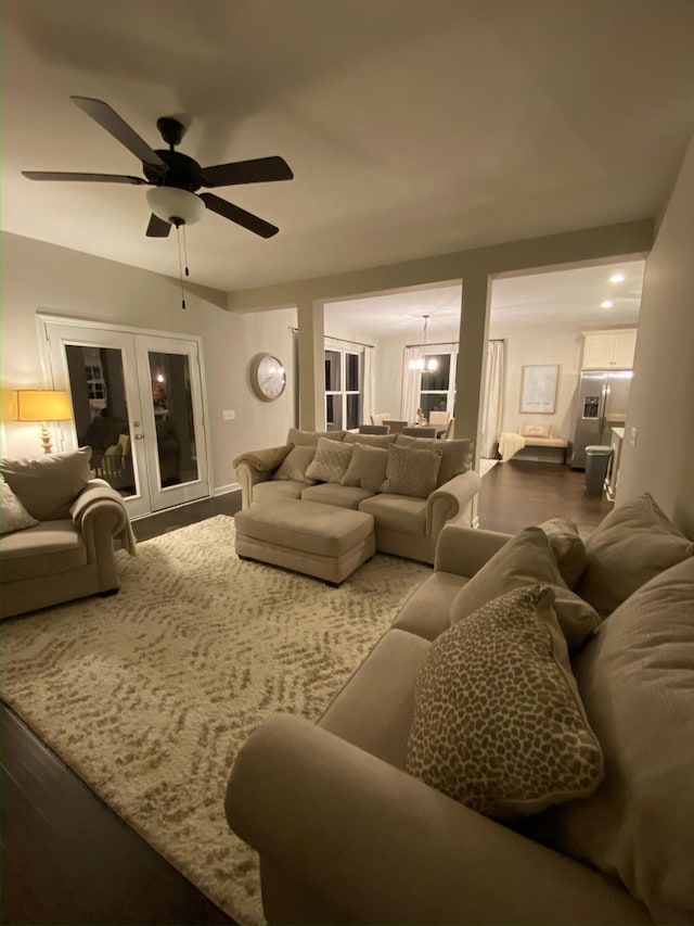 living area with ceiling fan, french doors, and wood finished floors