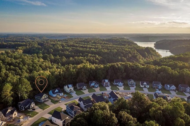 aerial view featuring a water view, a residential view, and a view of trees