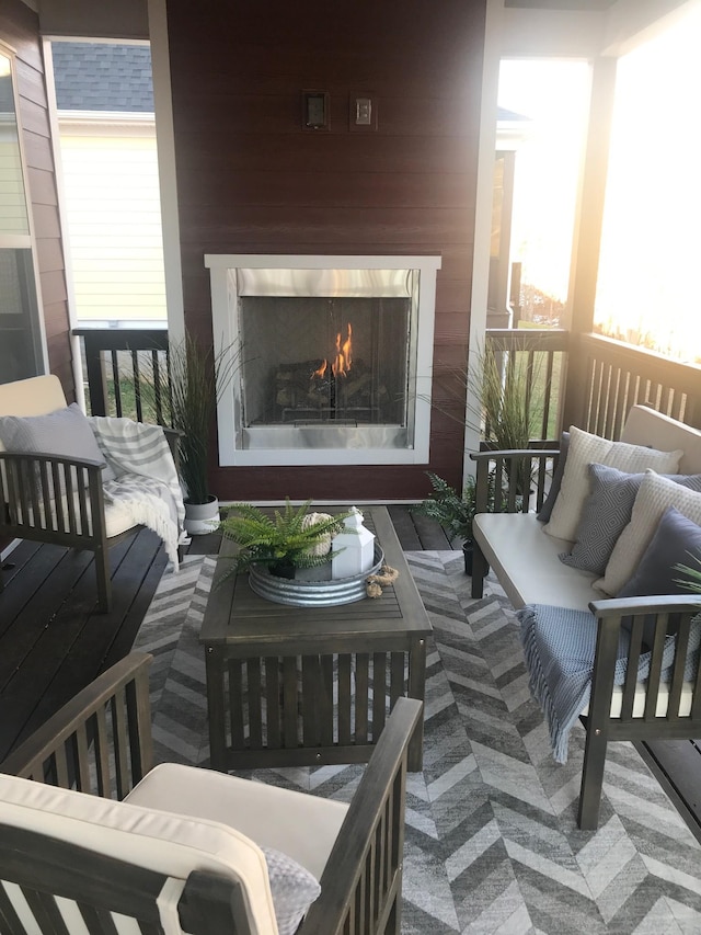 balcony featuring an outdoor living space with a fireplace