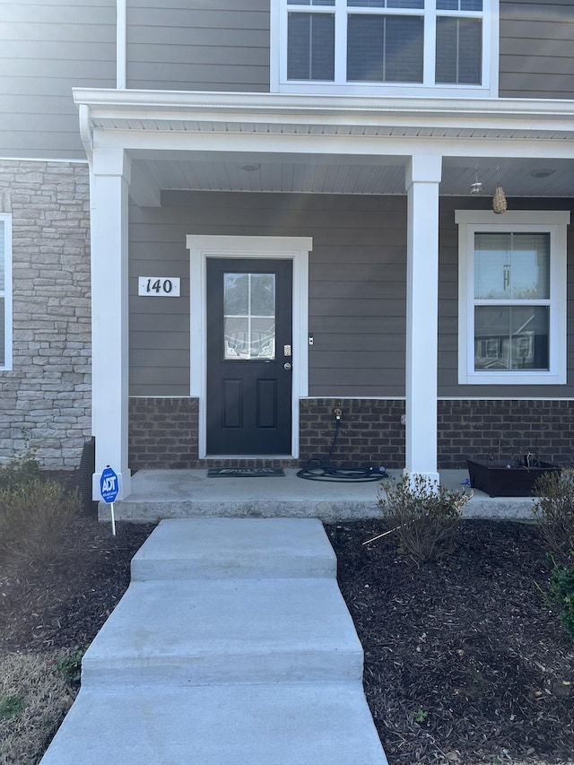 doorway to property featuring covered porch