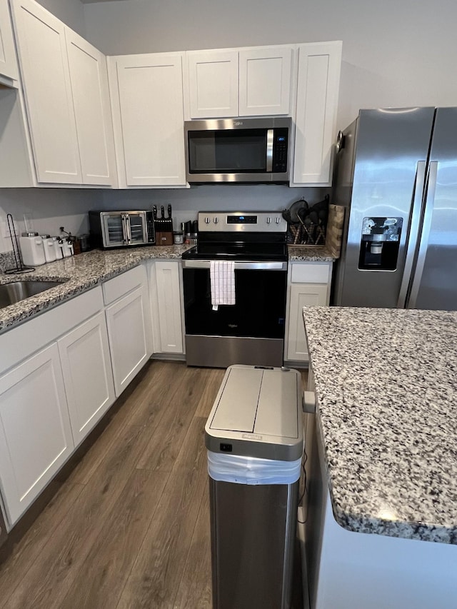 kitchen with white cabinetry, sink, dark hardwood / wood-style flooring, and stainless steel appliances