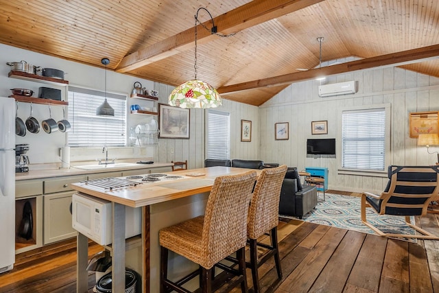 kitchen with a wall mounted air conditioner, decorative light fixtures, vaulted ceiling with beams, sink, and dark hardwood / wood-style flooring