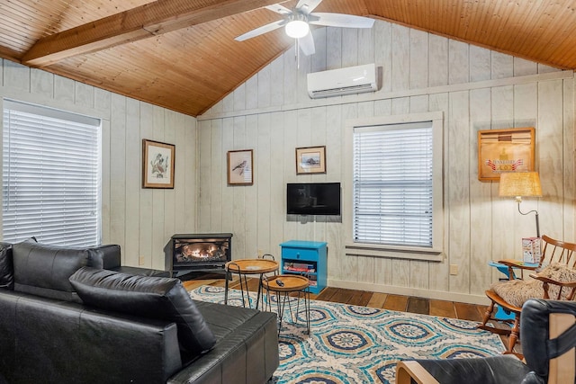 living room featuring ceiling fan, a wall mounted air conditioner, wood-type flooring, and vaulted ceiling with beams