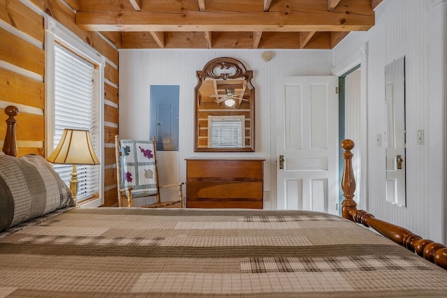 bedroom with beam ceiling and electric panel