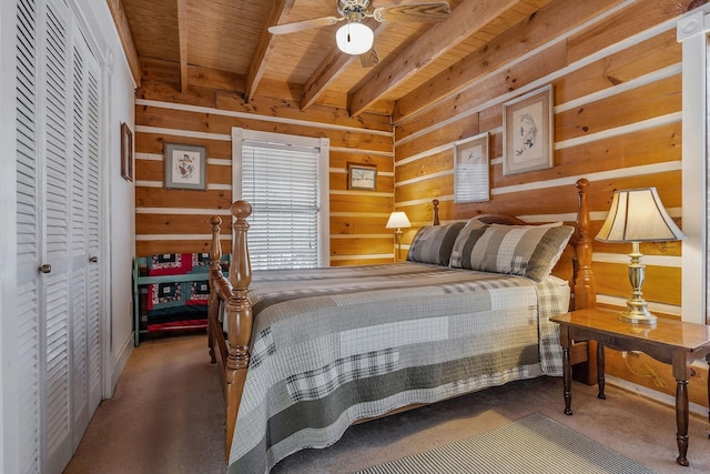 bedroom with wood ceiling, carpet flooring, wooden walls, and beam ceiling