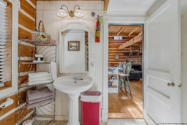 bathroom with wood-type flooring and wooden walls