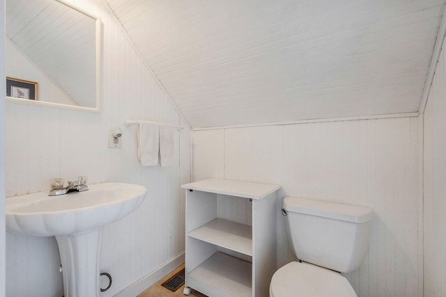 bathroom featuring vaulted ceiling, sink, and toilet