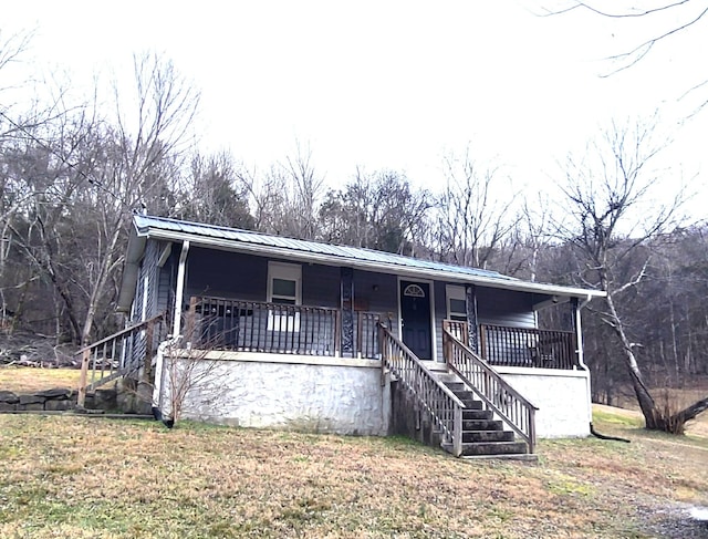 manufactured / mobile home with a porch and a front yard