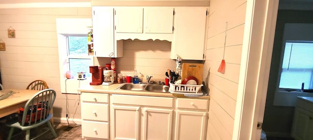 kitchen featuring sink and white cabinets