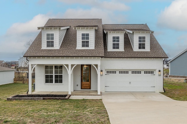 view of front facade with a garage, a porch, and a front lawn