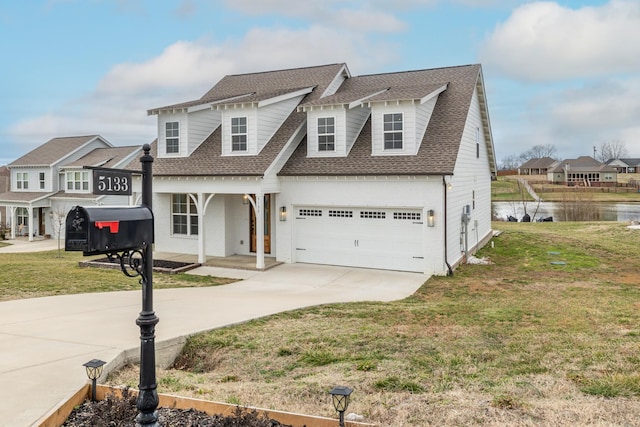 view of front of property featuring a garage, a water view, and a front yard