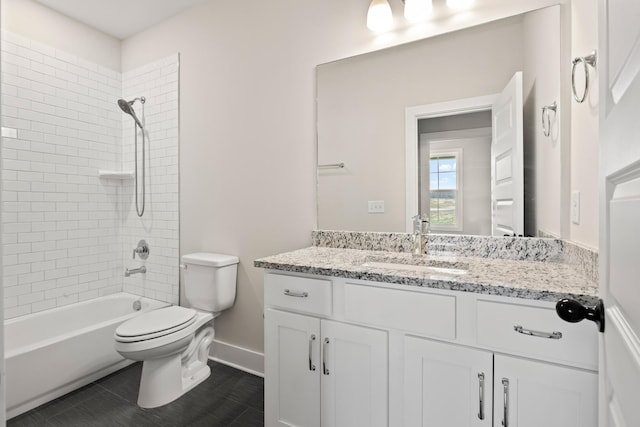 full bathroom with vanity, toilet, and tiled shower / bath