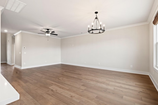 spare room featuring crown molding, ceiling fan with notable chandelier, and light wood-type flooring