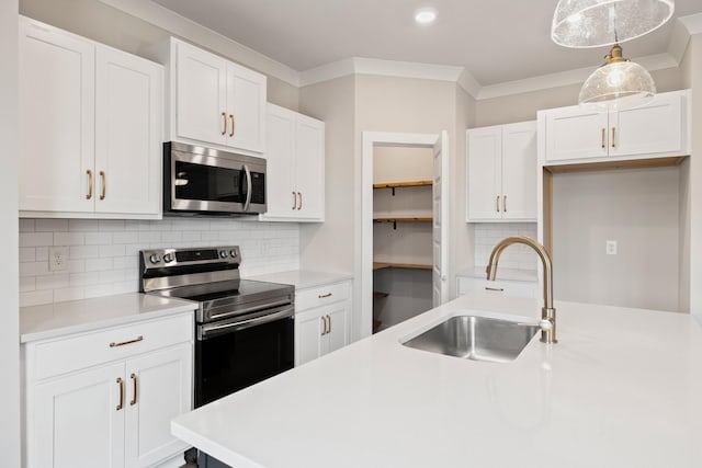 kitchen with sink, white cabinetry, hanging light fixtures, ornamental molding, and stainless steel appliances