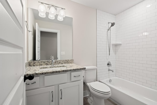 full bathroom with vanity, toilet, and tiled shower / bath