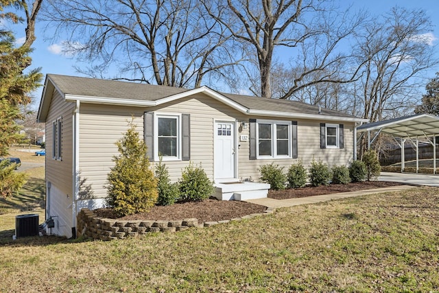 view of front of property featuring a carport, a front yard, and central air condition unit