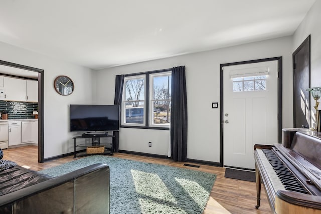 living room with plenty of natural light and light hardwood / wood-style floors