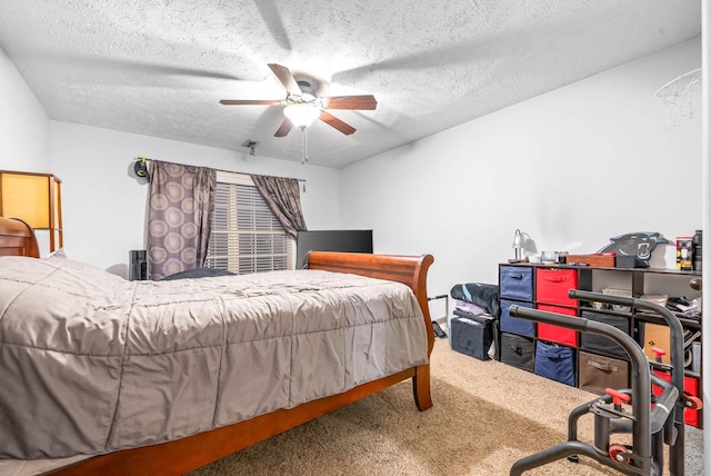 bedroom featuring ceiling fan, carpet, and a textured ceiling