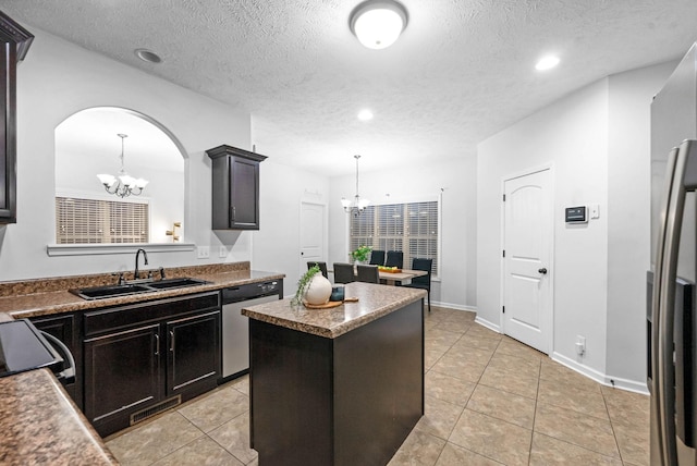 kitchen featuring an inviting chandelier, sink, a center island, and appliances with stainless steel finishes