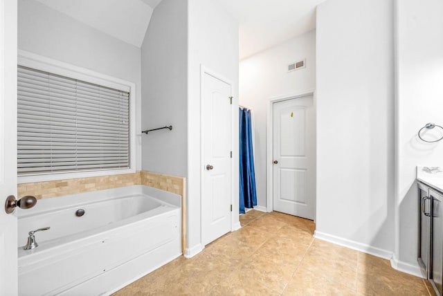 bathroom featuring vanity, tile patterned flooring, and a bathing tub