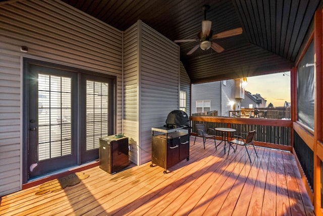 deck at dusk featuring ceiling fan