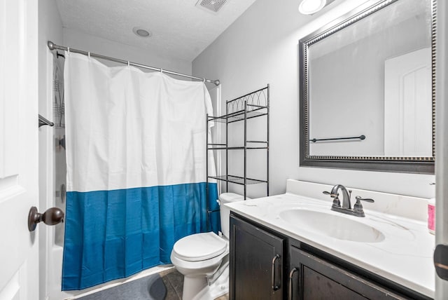 full bathroom with shower / bath combination with curtain, vanity, toilet, and a textured ceiling