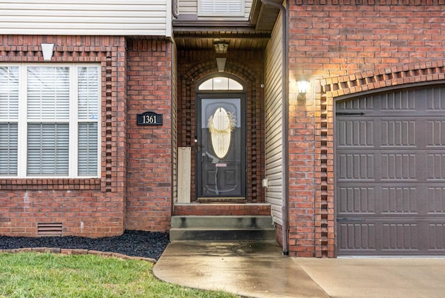 view of exterior entry featuring a garage