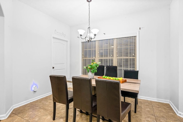 dining area featuring an inviting chandelier and tile patterned floors