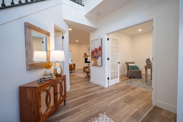 corridor featuring hardwood / wood-style flooring and french doors