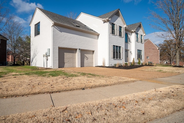 view of front of house with a garage and a front lawn