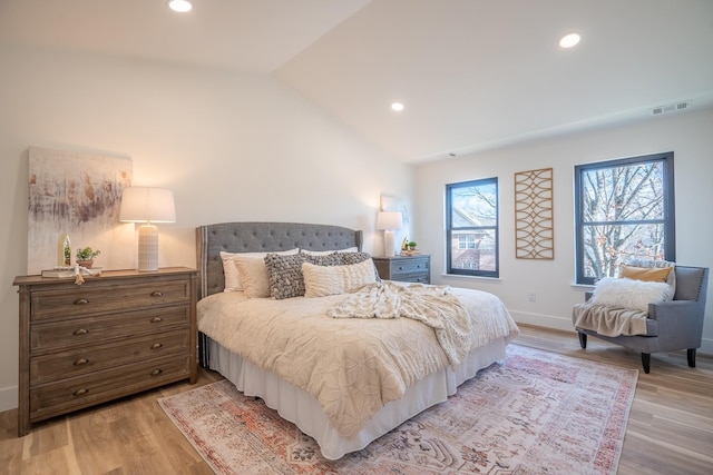 bedroom featuring lofted ceiling and light wood-type flooring