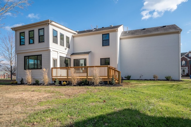 back of property with a wooden deck and a yard