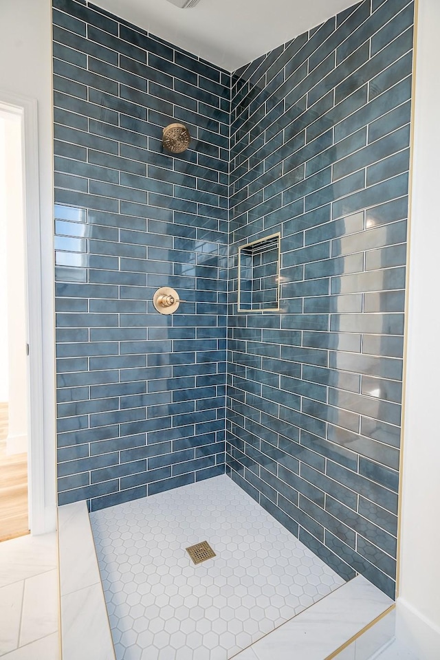 bathroom with a tile shower