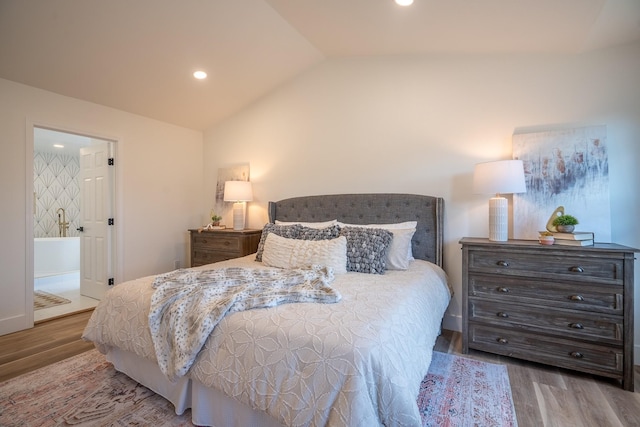 bedroom with hardwood / wood-style flooring and vaulted ceiling