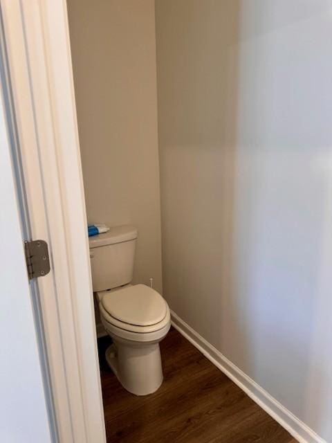 bathroom with hardwood / wood-style floors and toilet