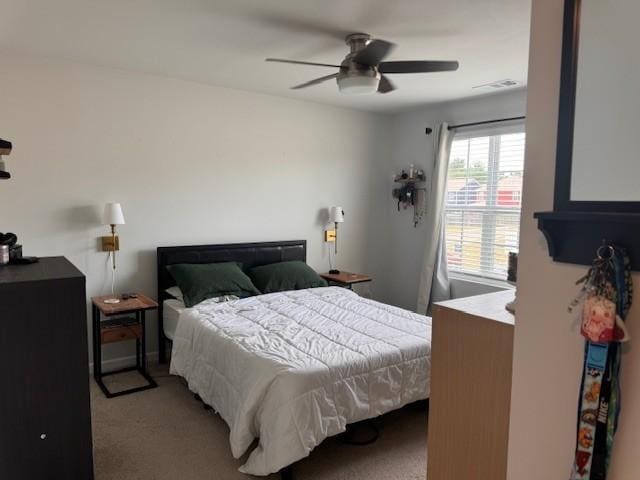 bedroom with ceiling fan and carpet floors