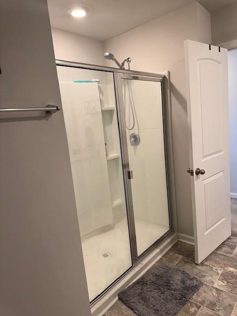 bathroom featuring a shower with shower door