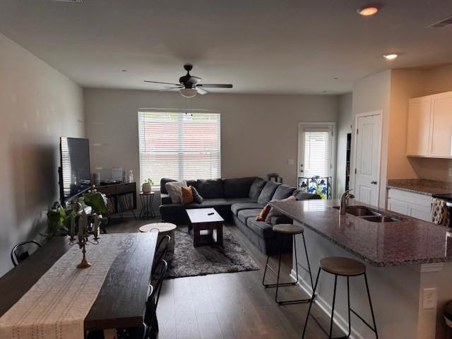 living room with sink, hardwood / wood-style floors, and ceiling fan