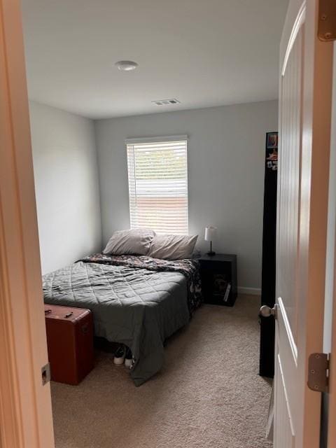 bedroom with light colored carpet